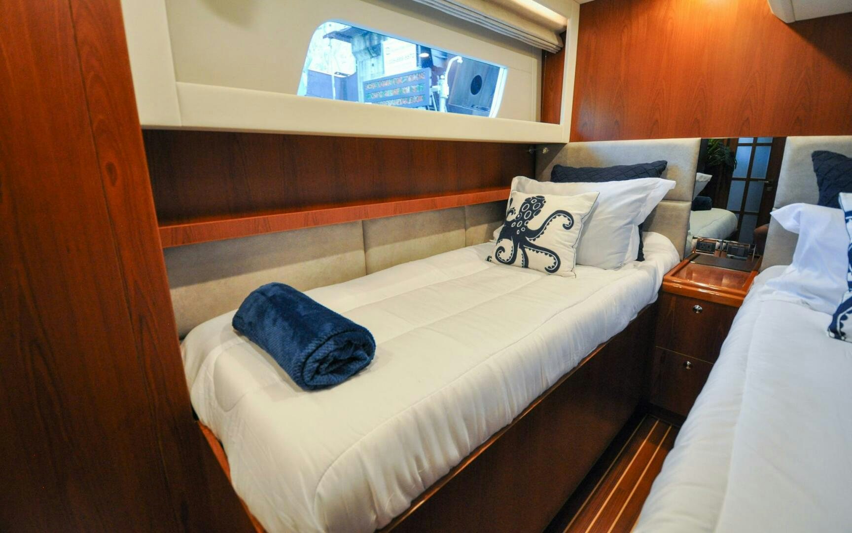 a room with a bed and a mirror aboard CASTINA Yacht for Sale