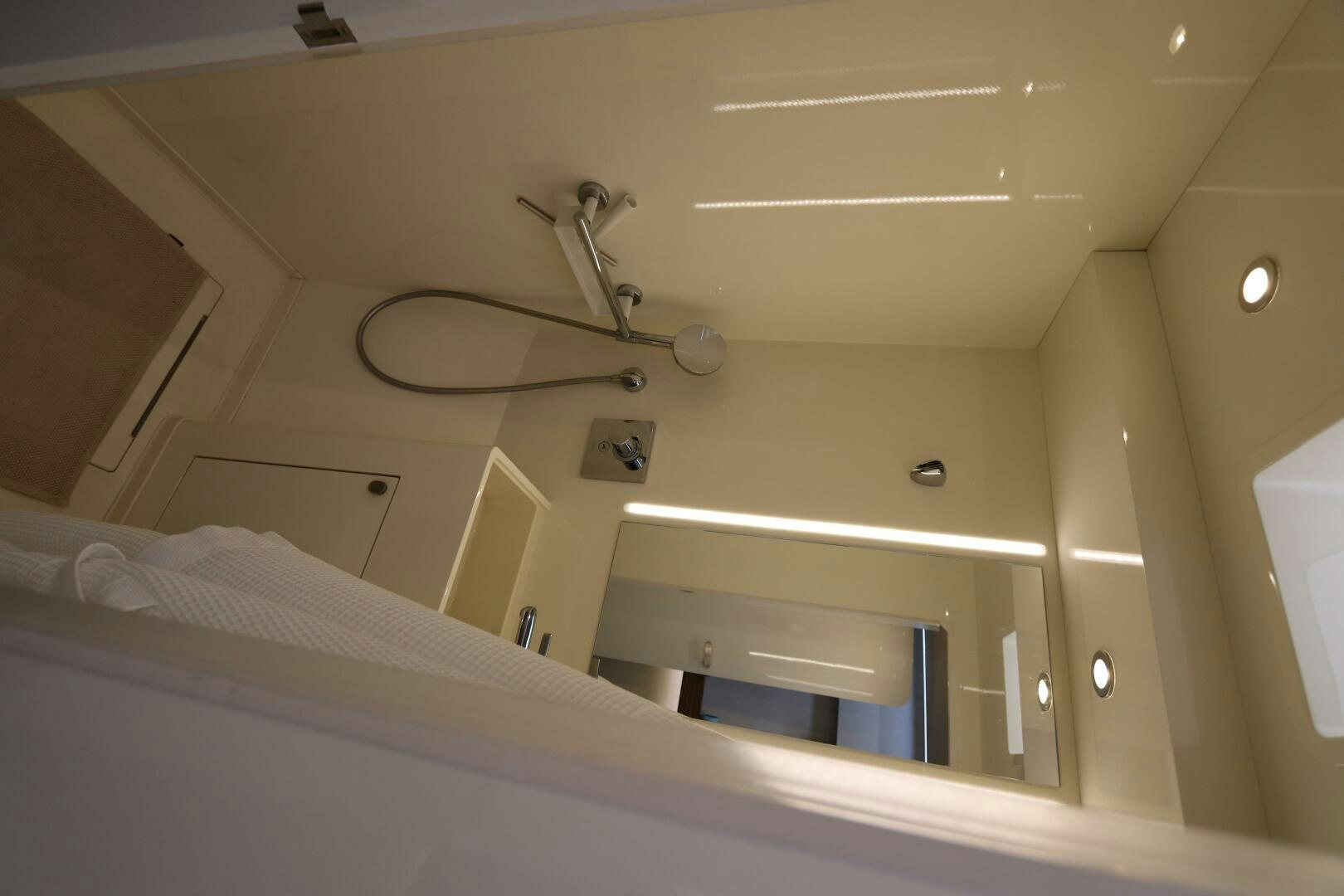 a white bathroom with a ceiling fan aboard CATCH ME Yacht for Sale