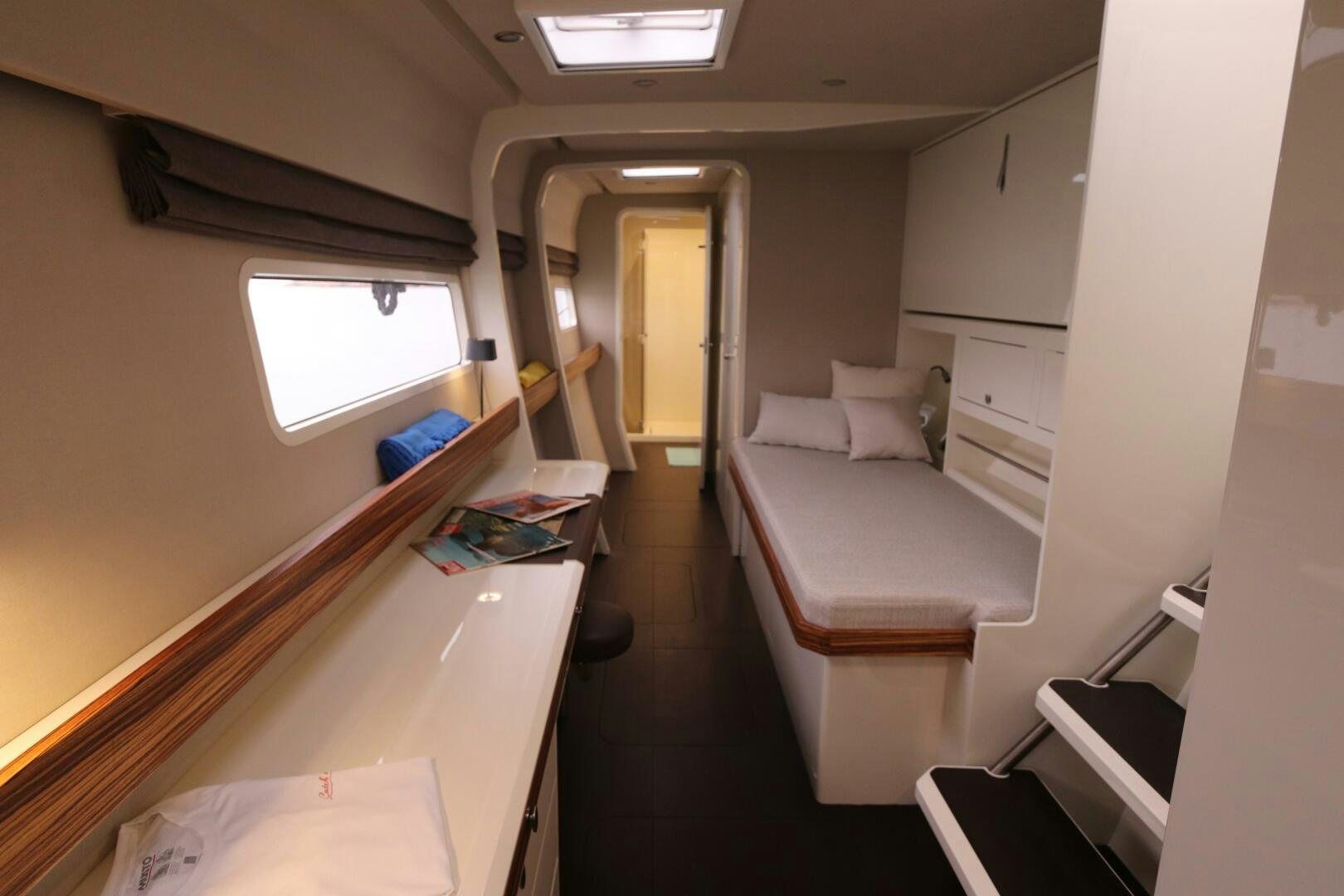 a room with a bed and a desk aboard CATCH ME Yacht for Sale