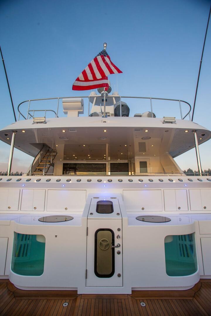 a boat with a flag on the front aboard CAZADOR Yacht for Sale