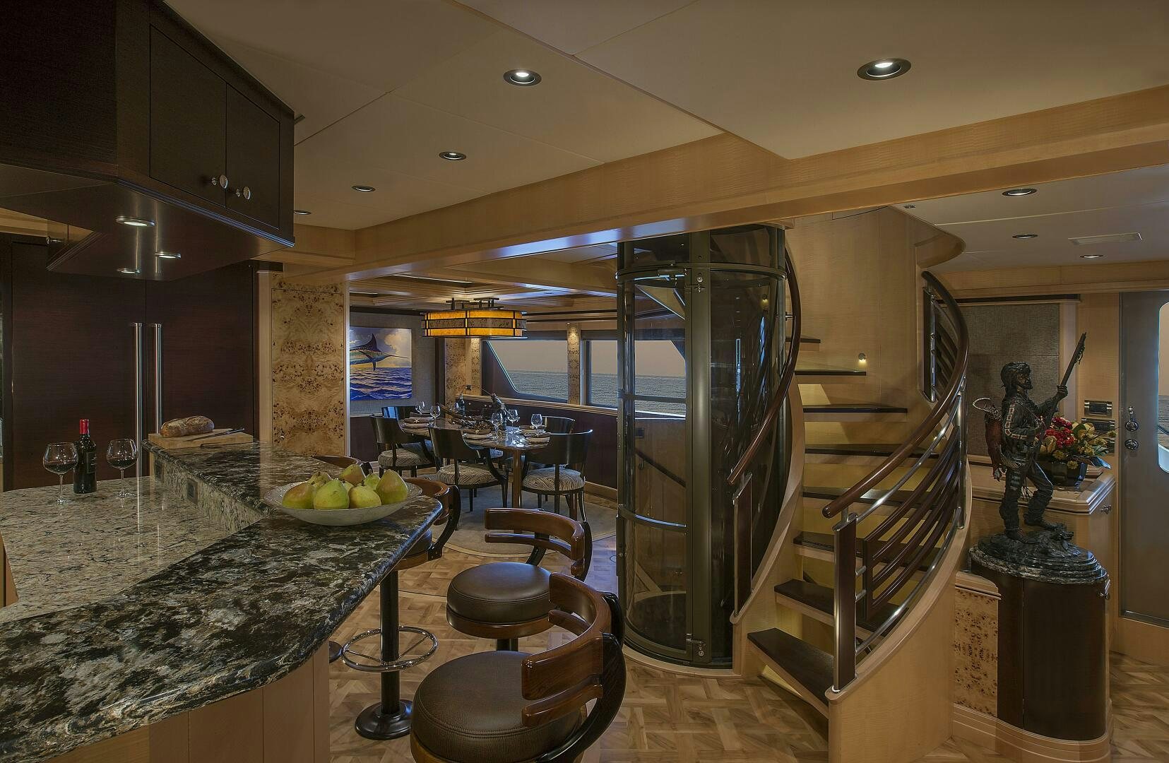 a kitchen with a large stainless steel refrigerator and a marble counter top aboard CAZADOR Yacht for Sale