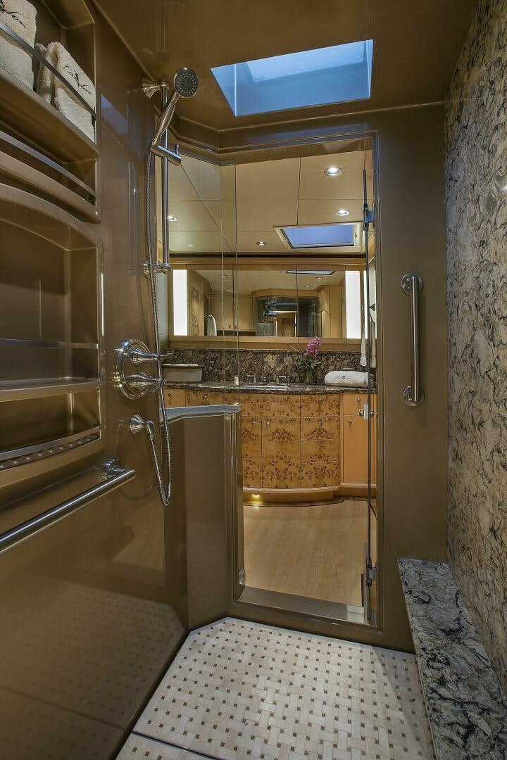 a bathroom with a large mirror aboard CAZADOR Yacht for Sale