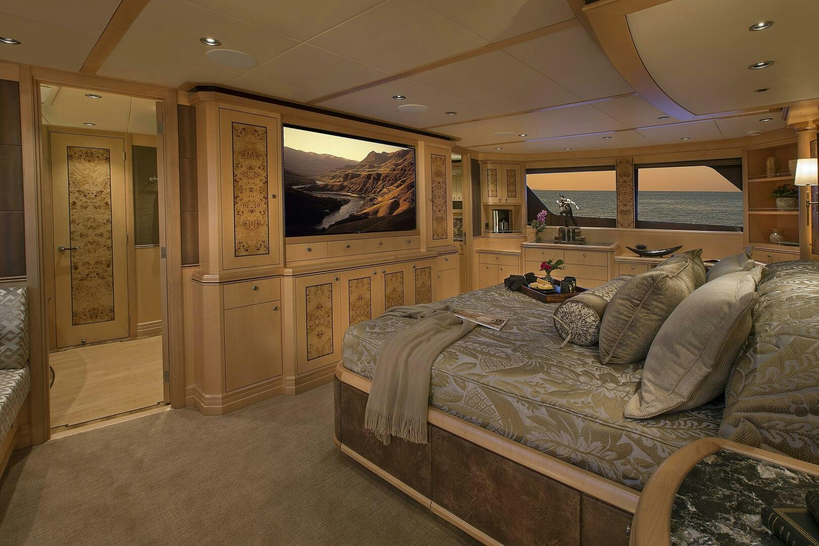 a bedroom with a bed and a dresser aboard CAZADOR Yacht for Sale