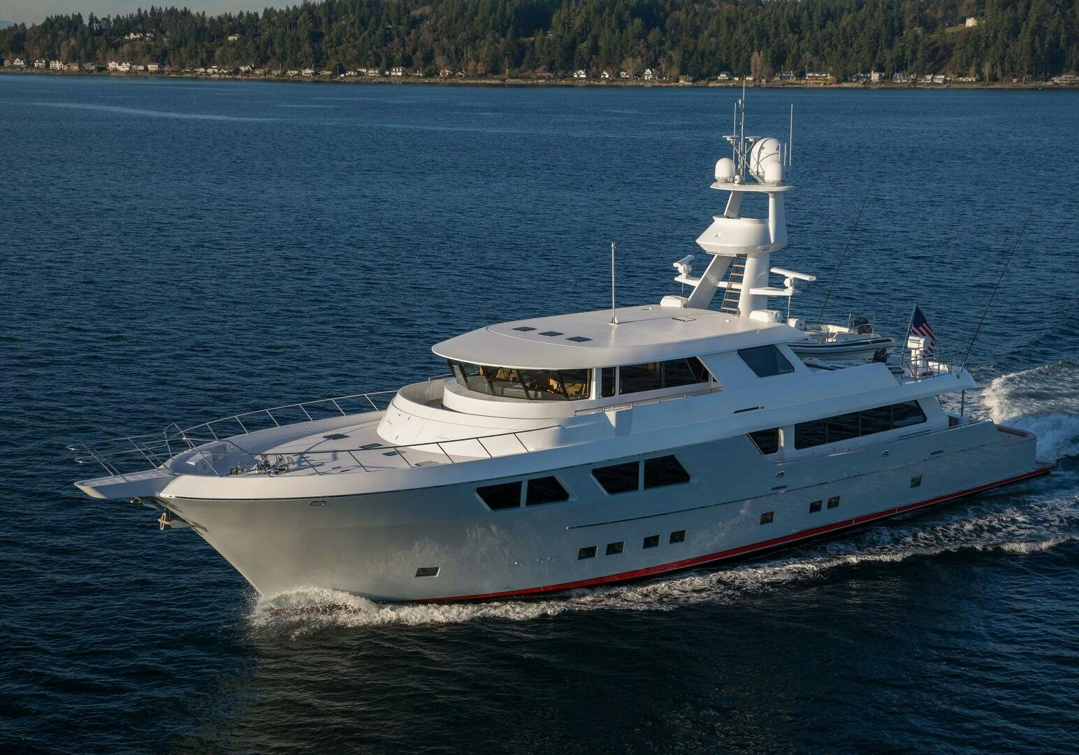 a large white boat on the water aboard CAZADOR Yacht for Sale