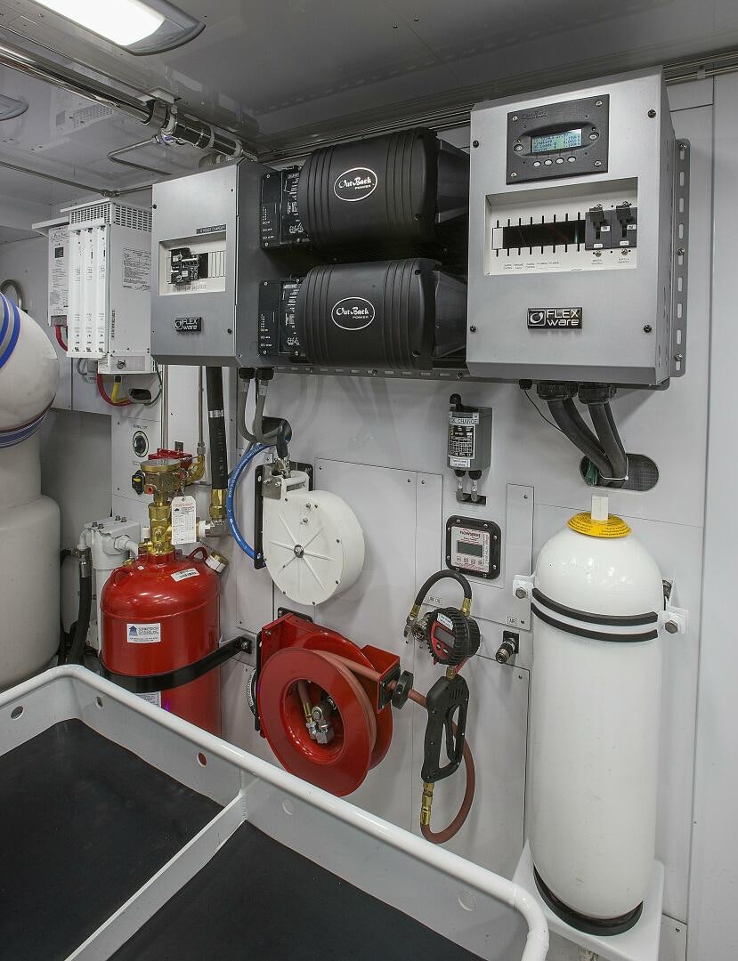 a white machine with red and black tubes aboard CAZADOR Yacht for Sale