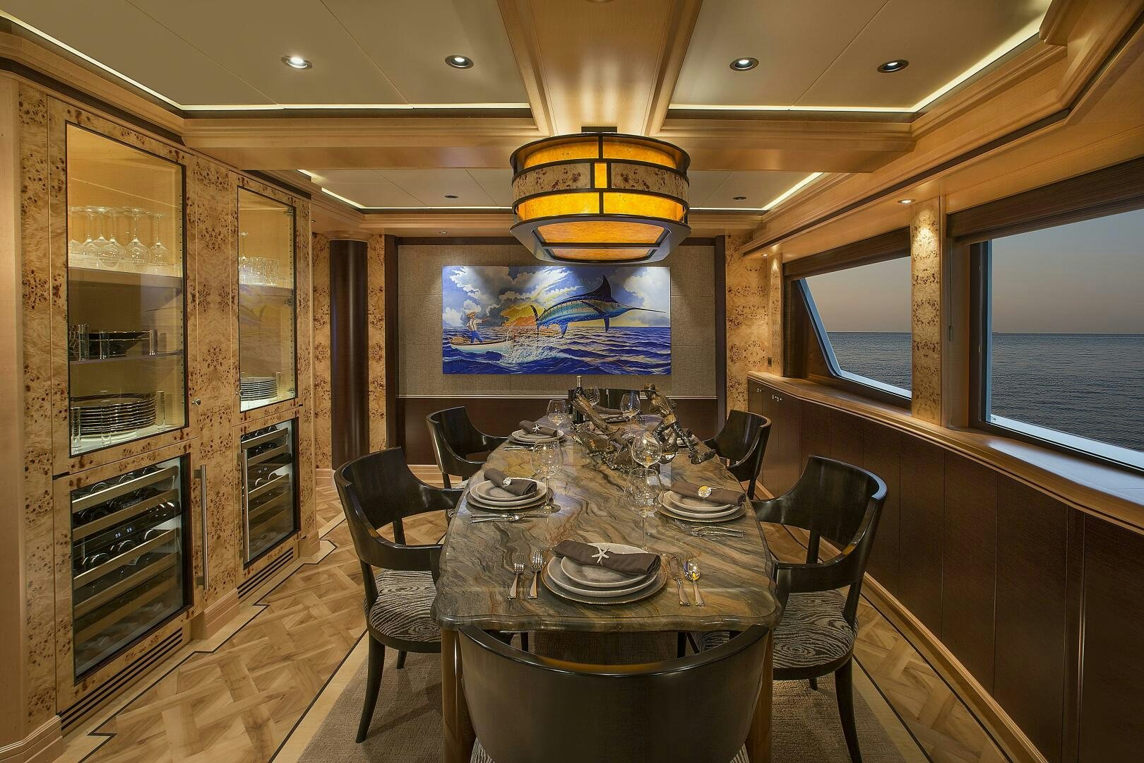 a dining room with a table aboard CAZADOR Yacht for Sale