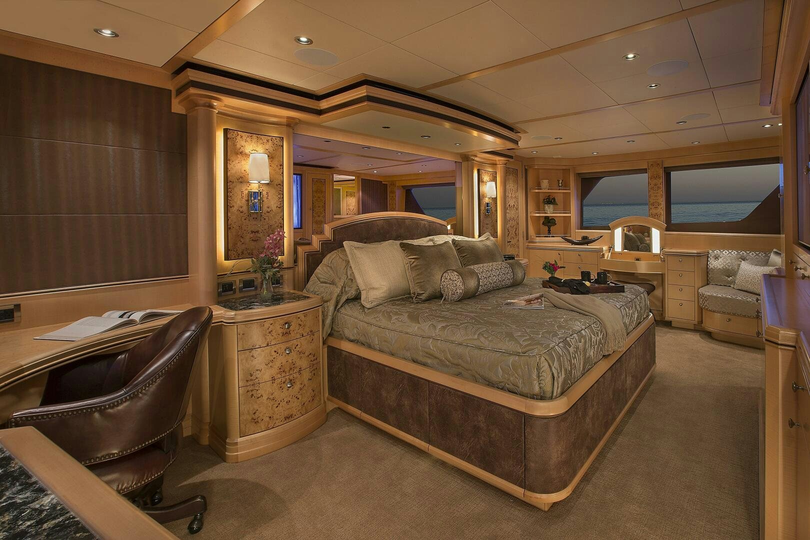 a bedroom with a bed and a chair aboard CAZADOR Yacht for Sale