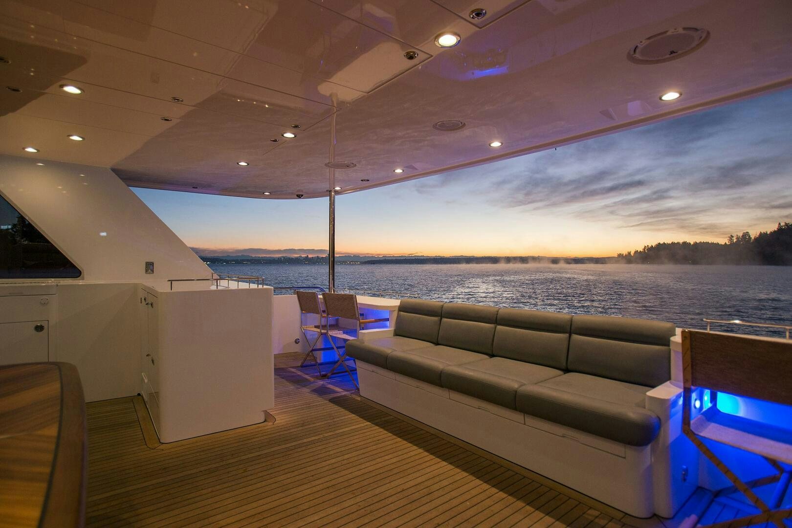 a large room with a couch and a table and chairs aboard CAZADOR Yacht for Sale
