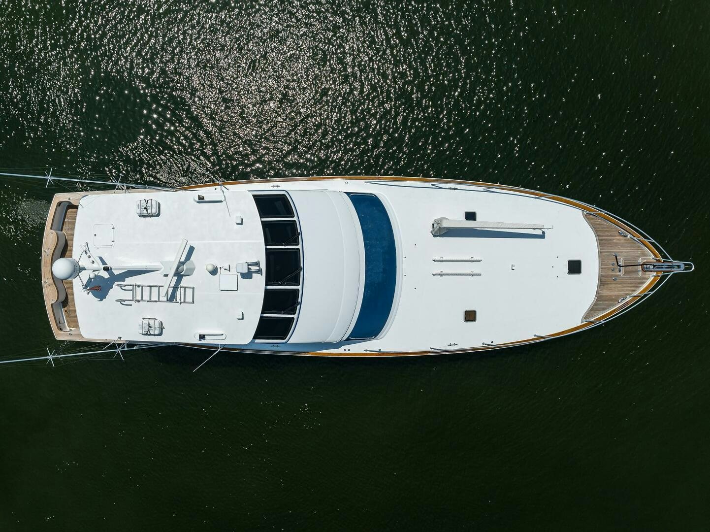 a white and blue boat on water aboard JR Yacht for Sale
