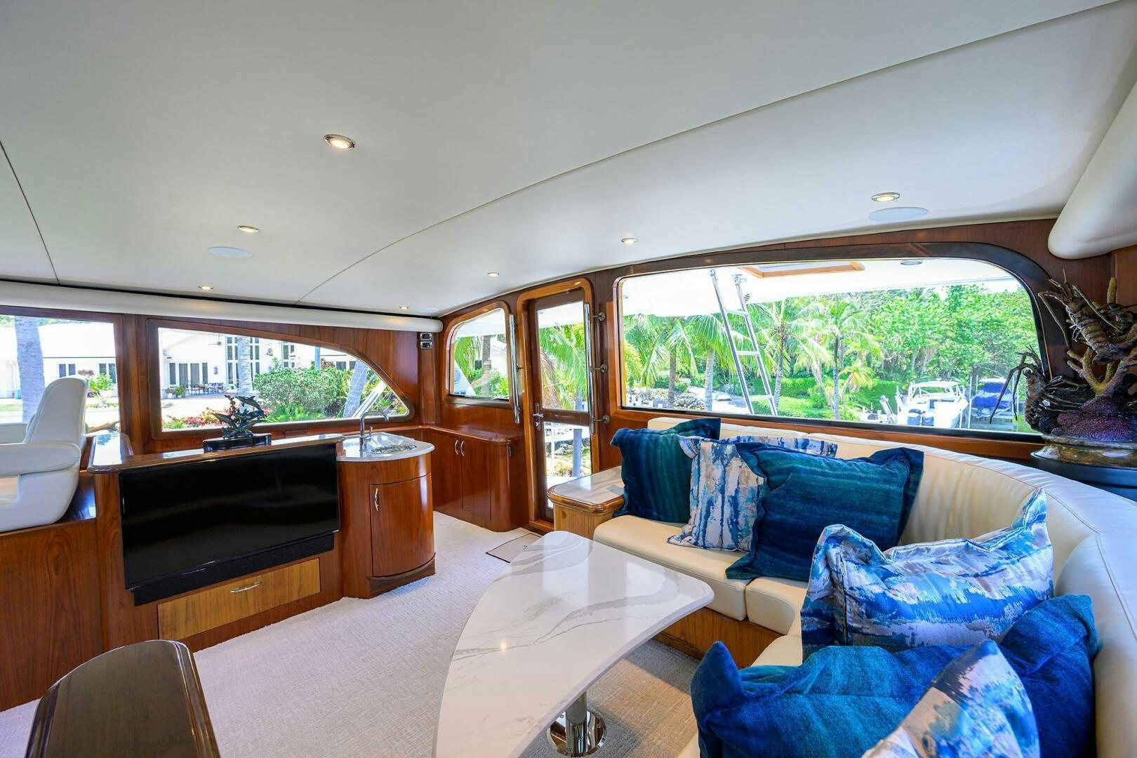 a living room with a piano and a large window aboard JR Yacht for Sale
