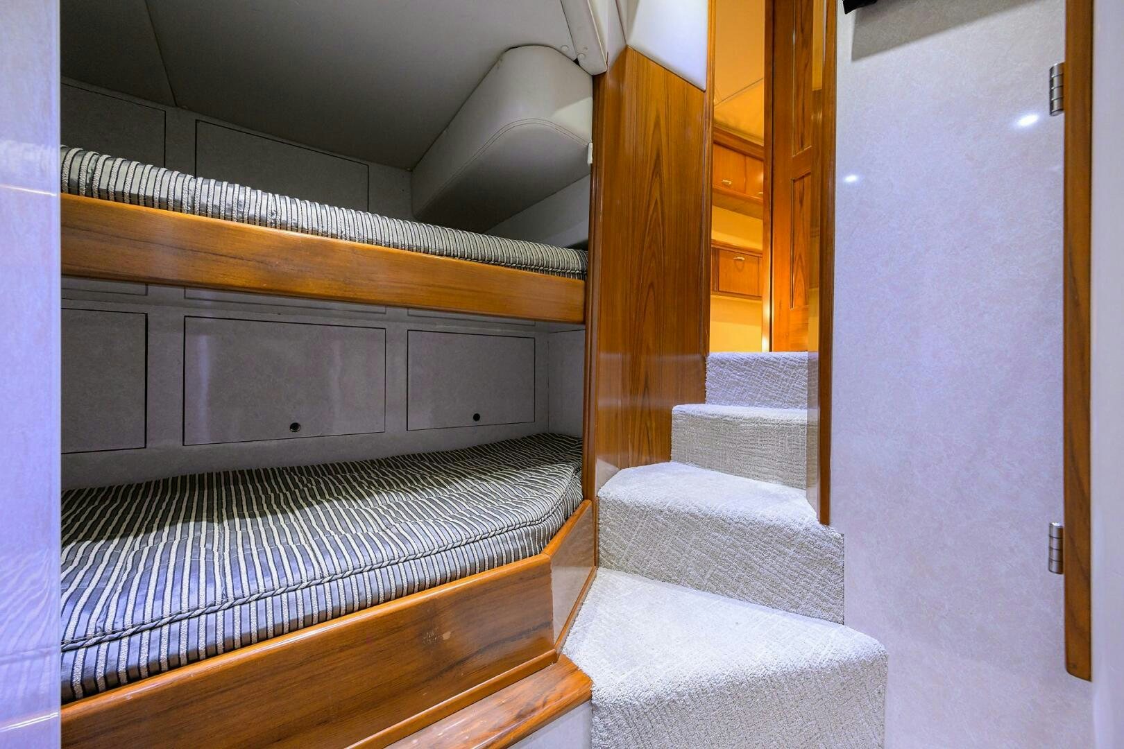 a staircase with a rug aboard JR Yacht for Sale