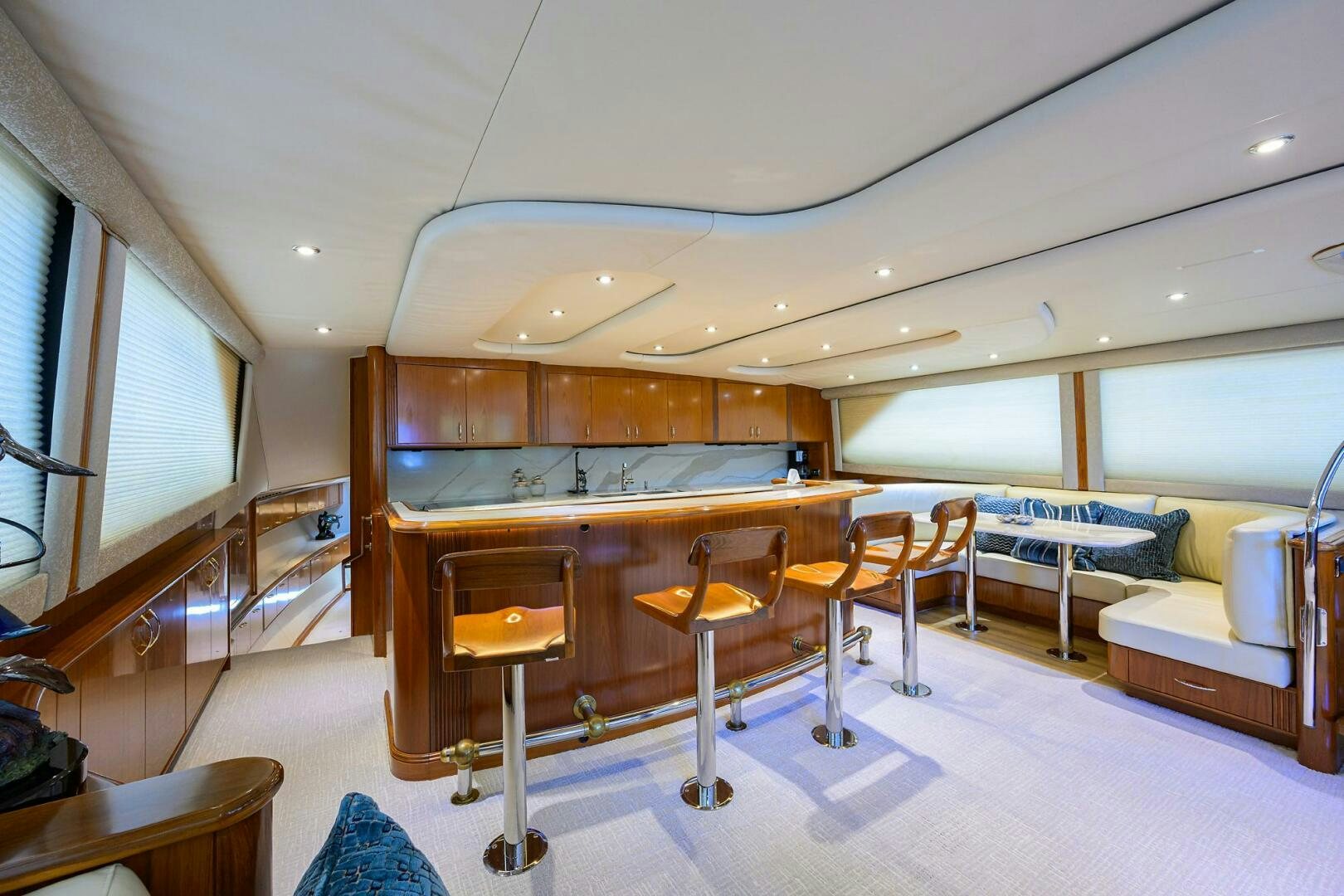 a room with a table and chairs aboard JR Yacht for Sale