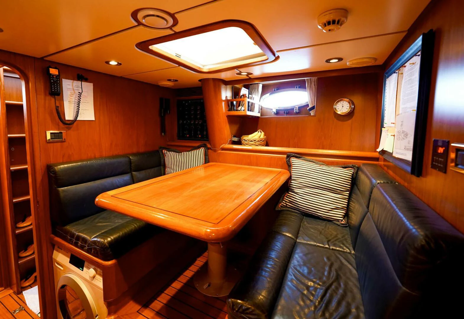 a room with leather couches and a table aboard IKARON Yacht for Sale