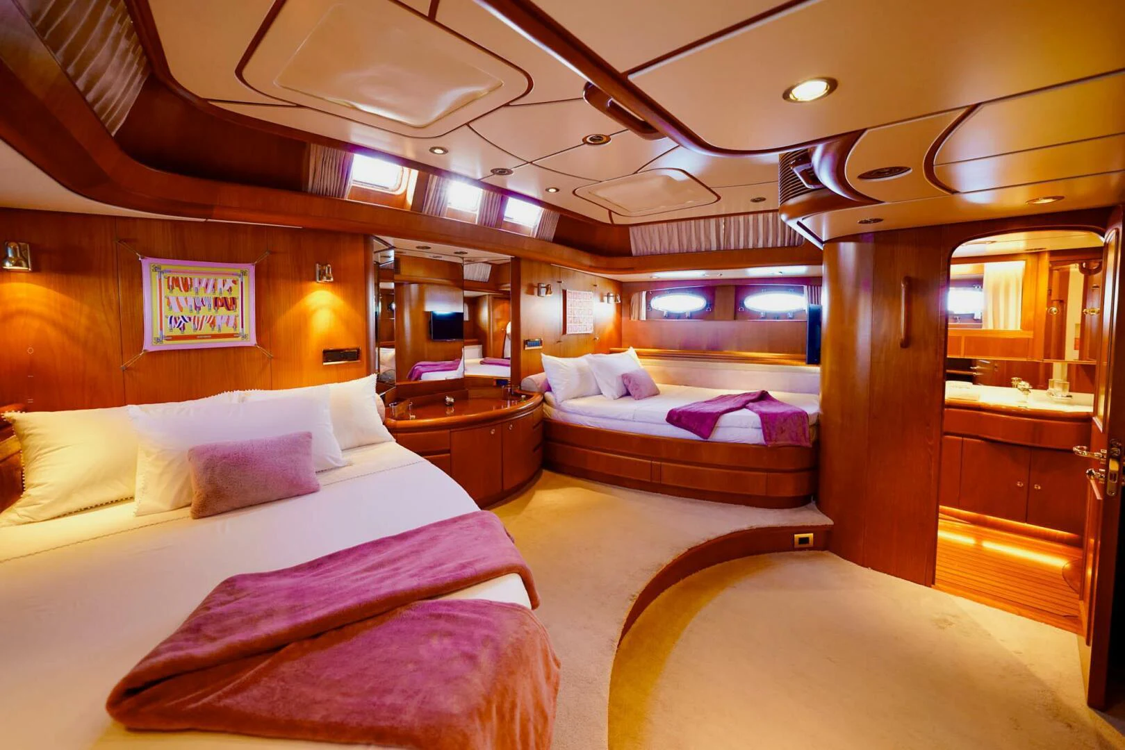 a room with a bed and a large window aboard IKARON Yacht for Sale