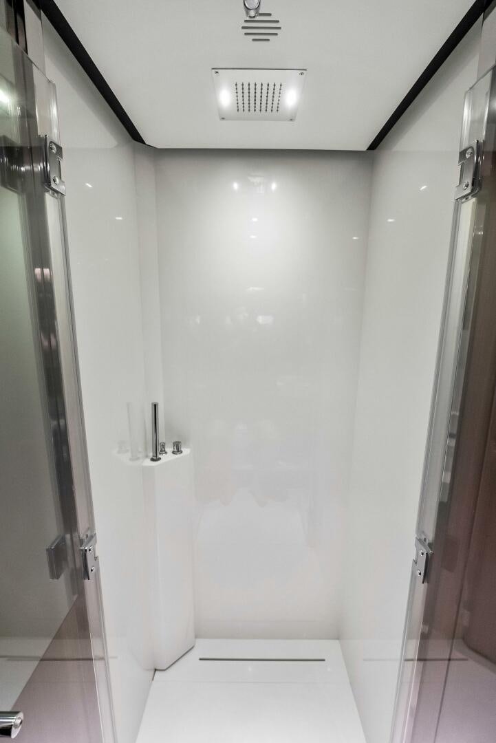 a bathroom with a door and a mirror aboard KNOT NORMAL Yacht for Sale