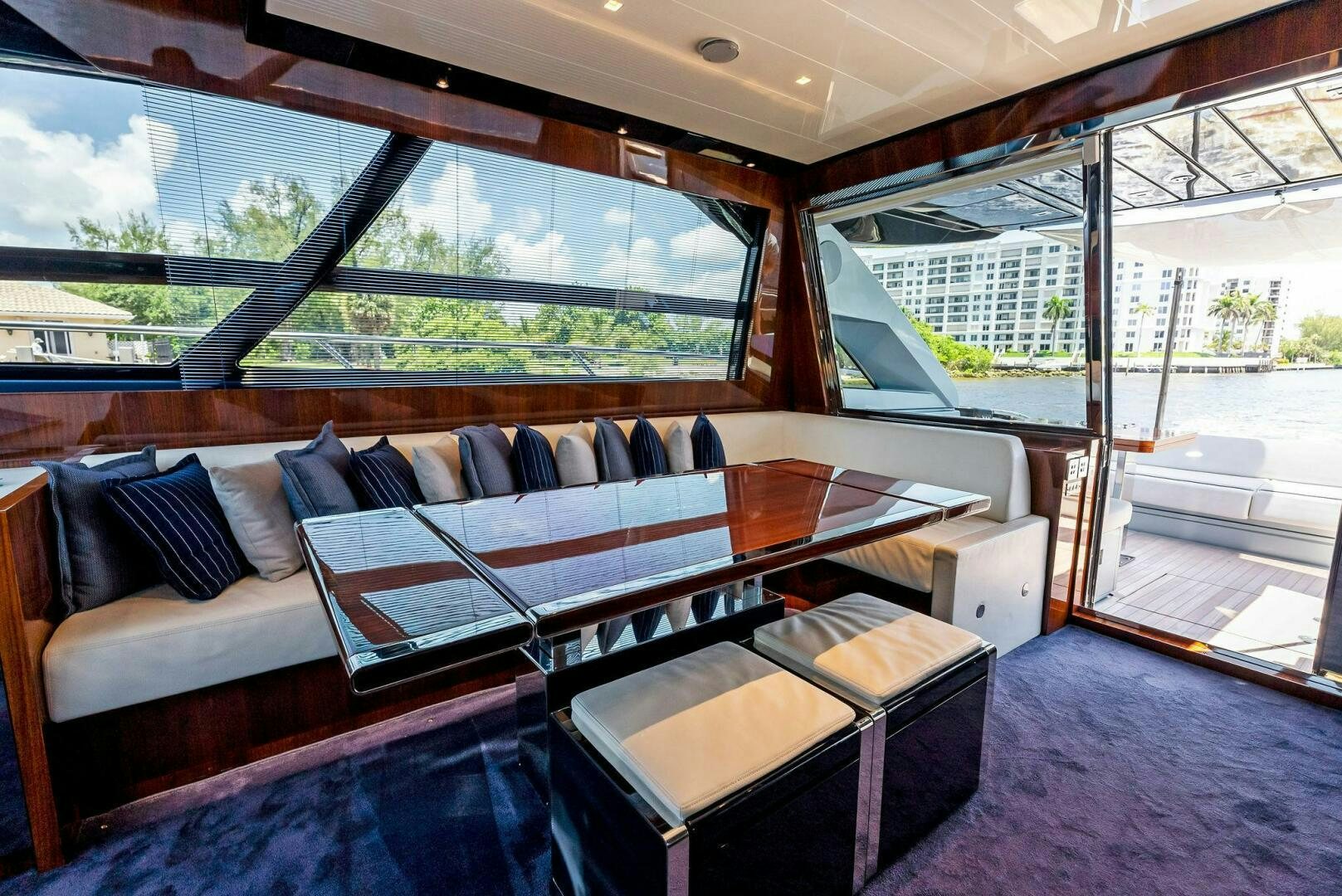 a couch and a table in a room with a large window aboard KNOT NORMAL Yacht for Sale