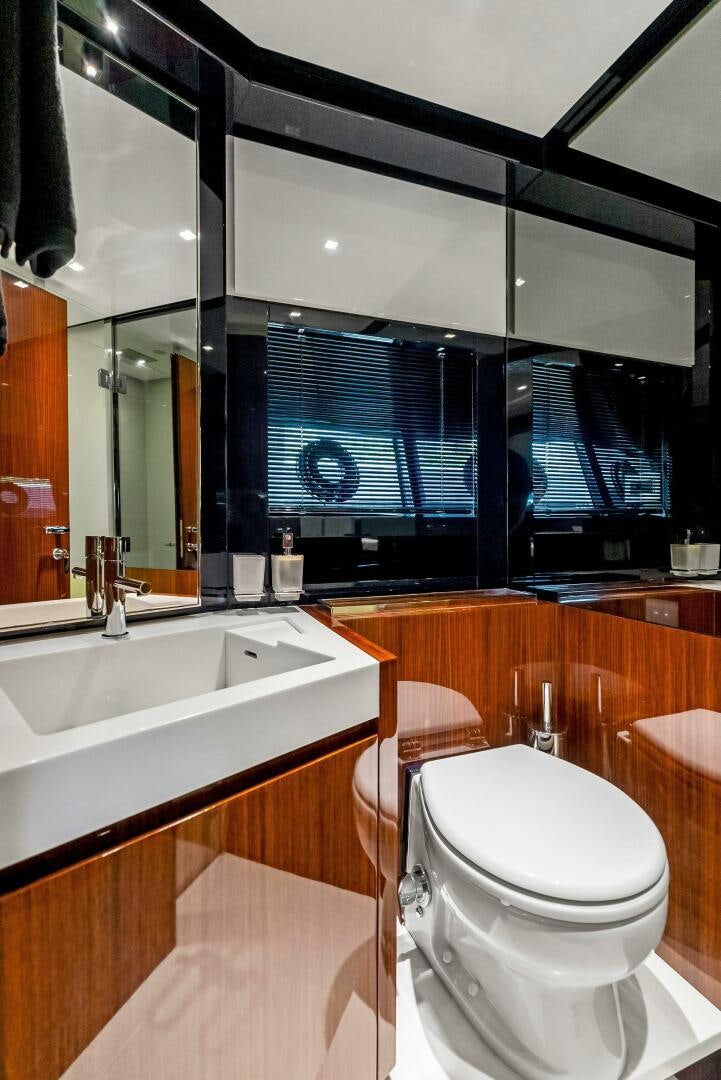 a bathroom with a toilet and a sink aboard KNOT NORMAL Yacht for Sale