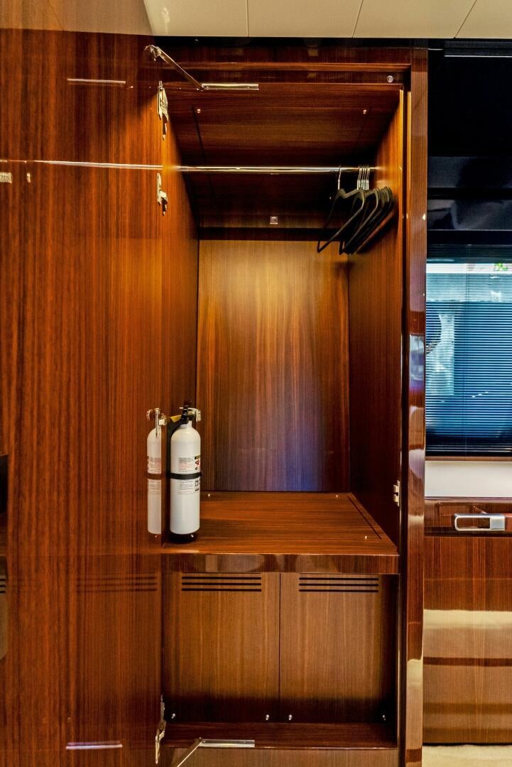 a wooden cabinet with a bottle of wine on it aboard KNOT NORMAL Yacht for Sale