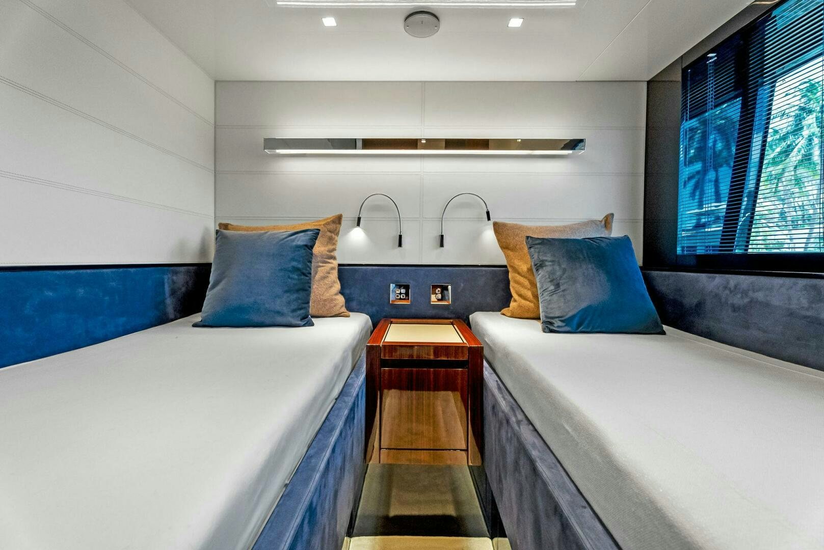 a room with beds and a sink aboard KNOT NORMAL Yacht for Sale