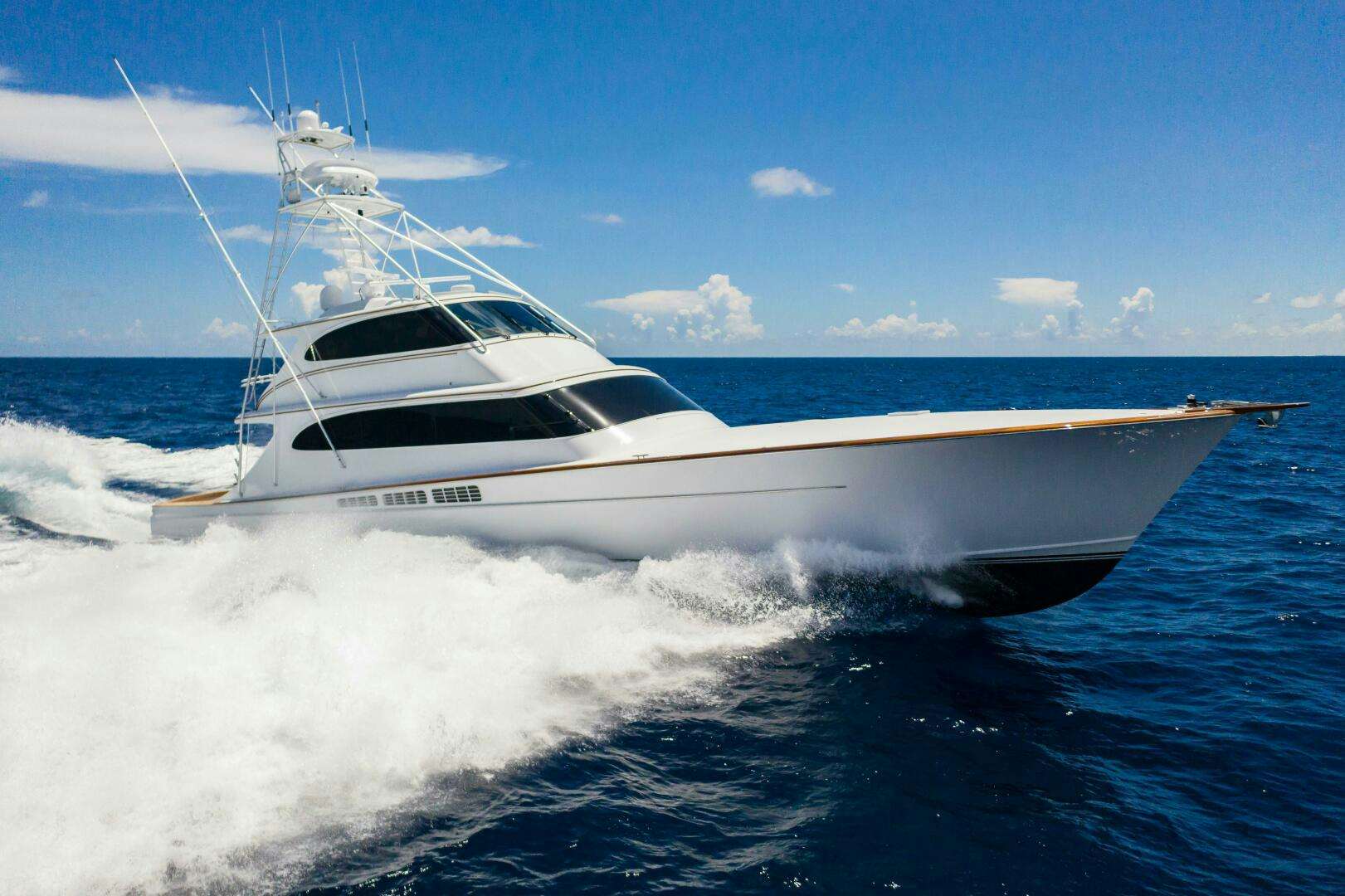 a white yacht on the water aboard III AMIGOS Yacht for Sale