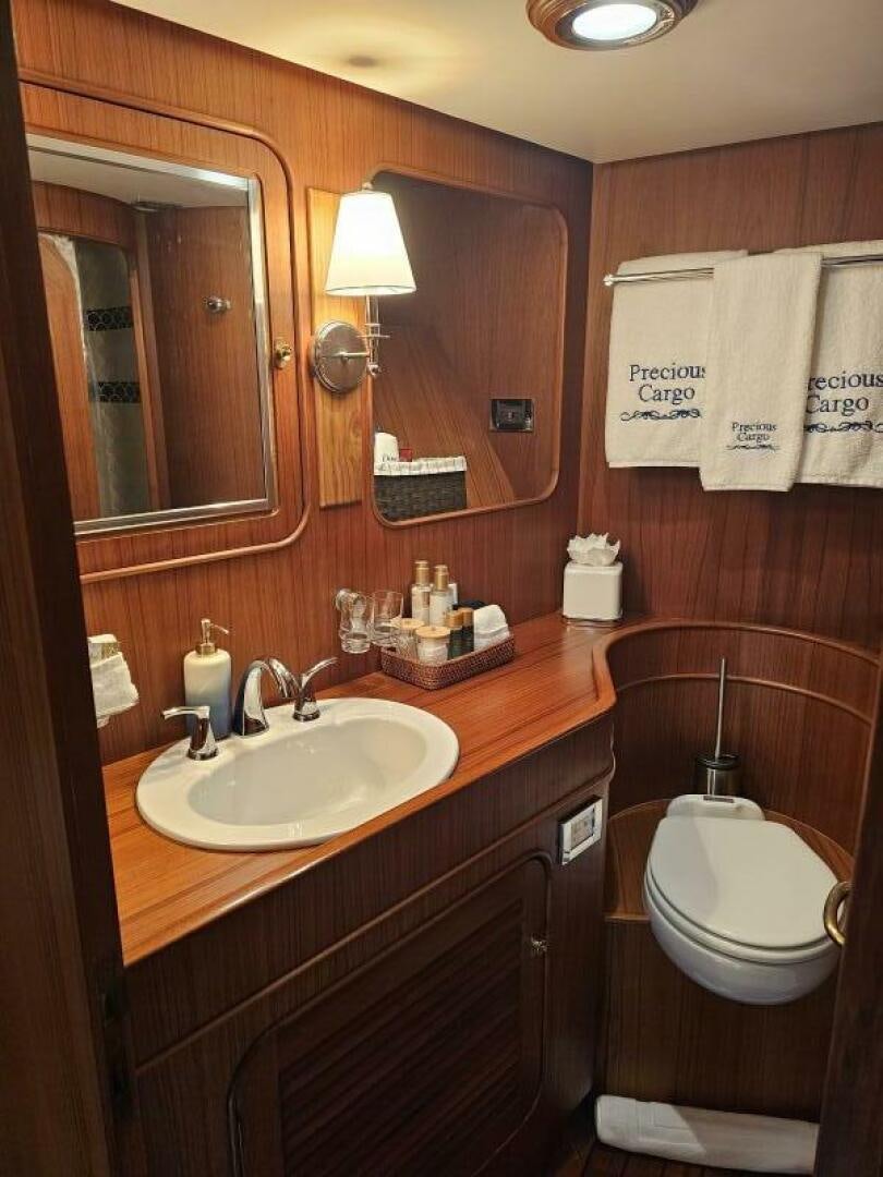 a bathroom with a toilet and a sink aboard PRECIOUS CARGO Yacht for Sale