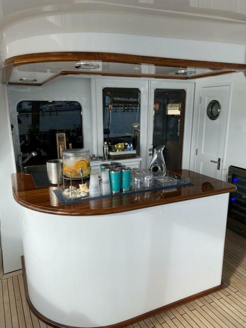 a glass table with glasses on it aboard PRECIOUS CARGO Yacht for Sale