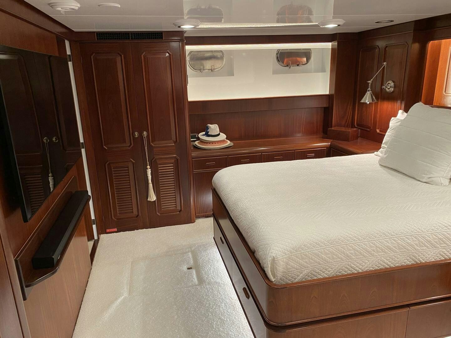 a bedroom with a bed and a television aboard PRECIOUS CARGO Yacht for Sale