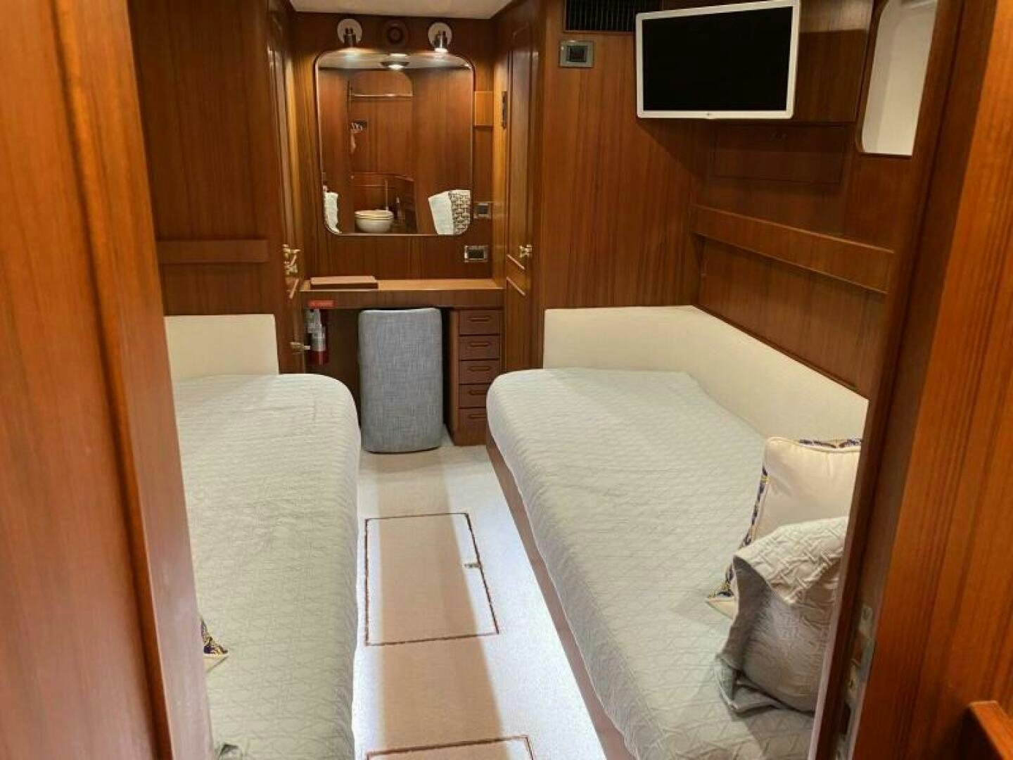 a room with a bed and a mirror aboard PRECIOUS CARGO Yacht for Sale