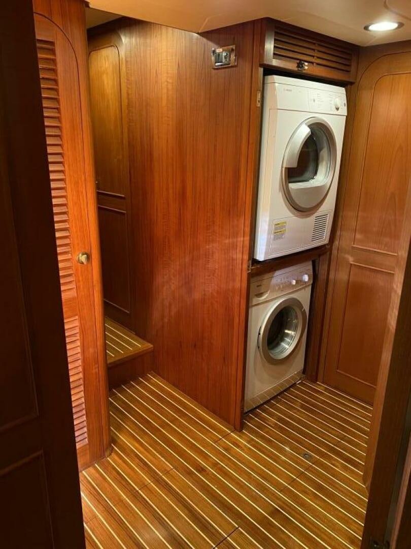 a washer and dryer in a wooden room aboard PRECIOUS CARGO Yacht for Sale