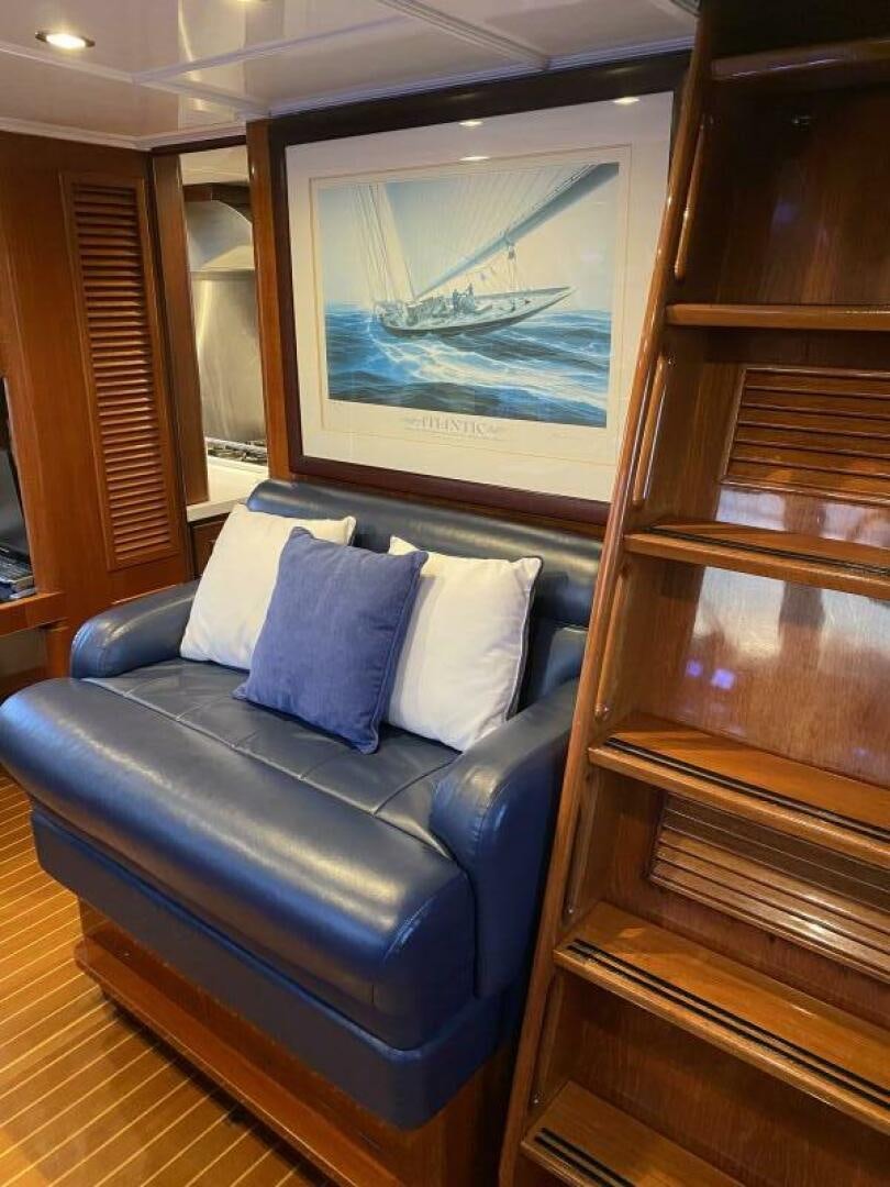 a blue couch in a room aboard PRECIOUS CARGO Yacht for Sale