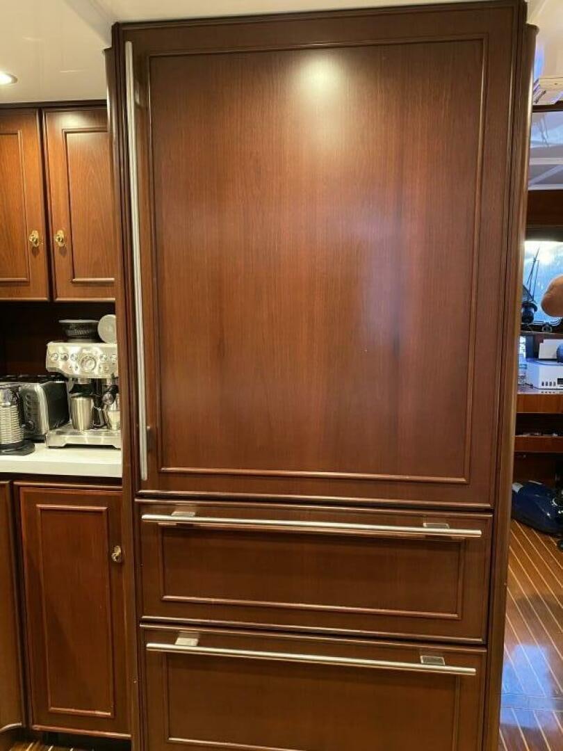 a wooden cabinet in a kitchen aboard PRECIOUS CARGO Yacht for Sale