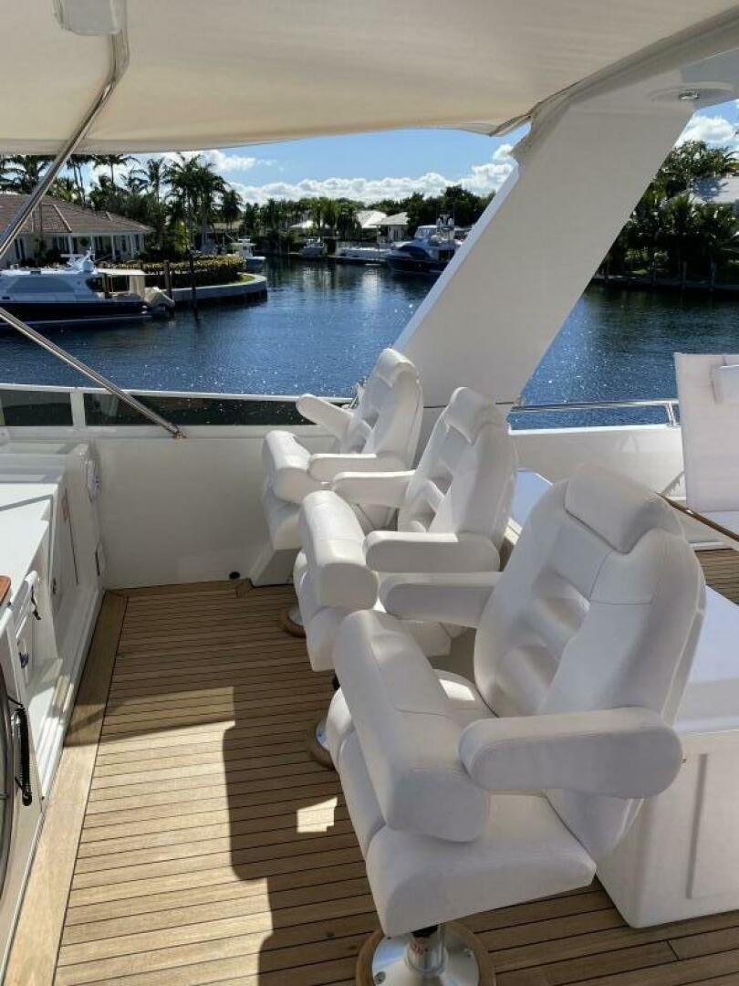 a white chair on a deck overlooking a body of water aboard PRECIOUS CARGO Yacht for Sale