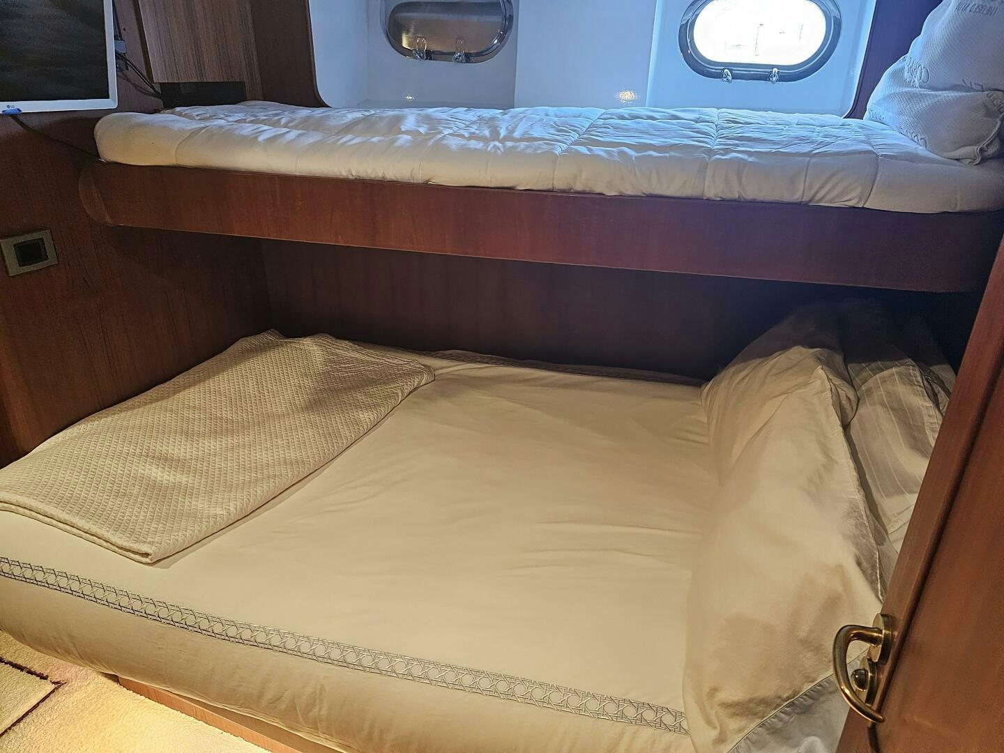 a bed with a blue blanket aboard PRECIOUS CARGO Yacht for Sale
