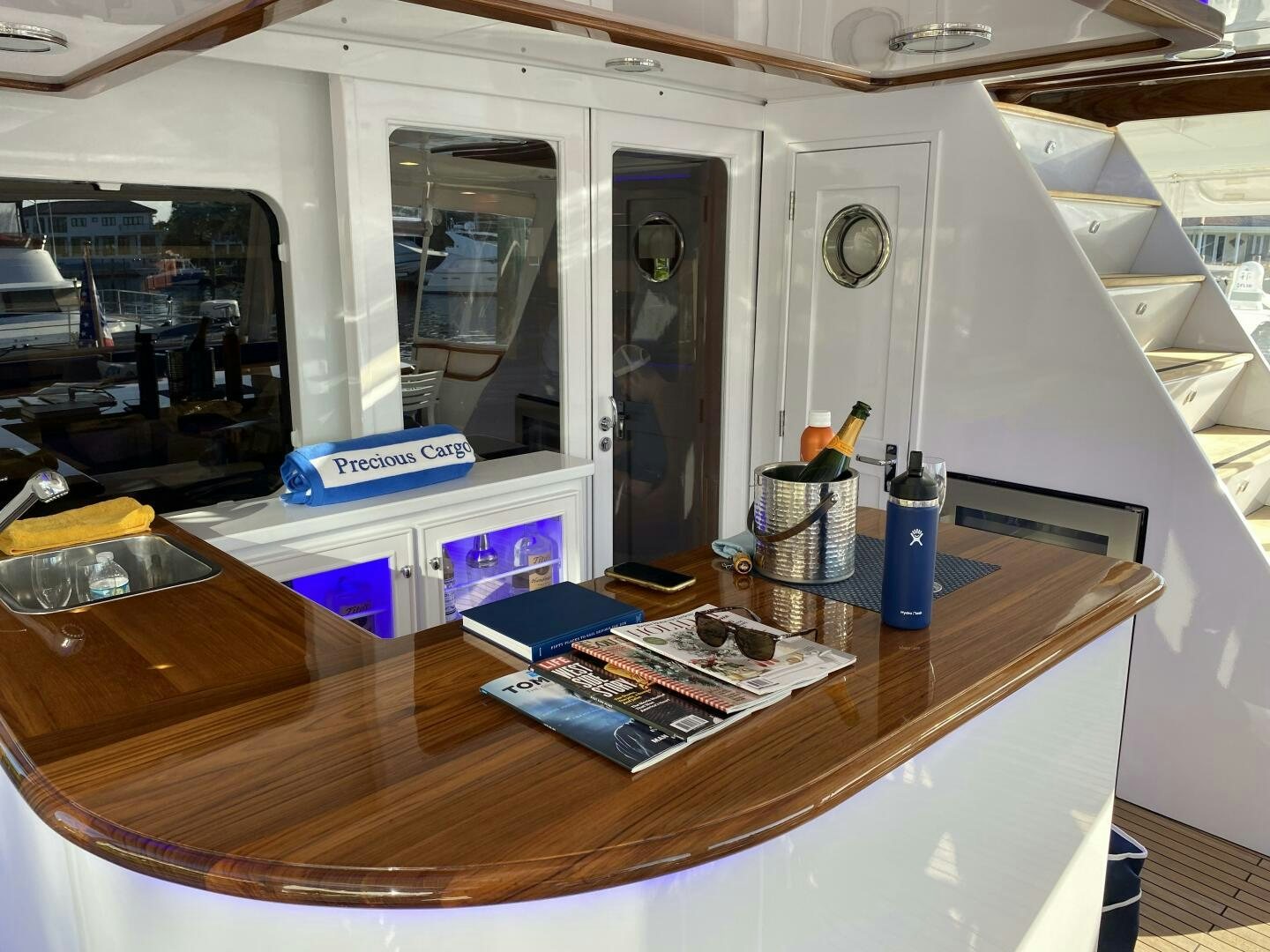a table with a book and a window aboard PRECIOUS CARGO Yacht for Sale
