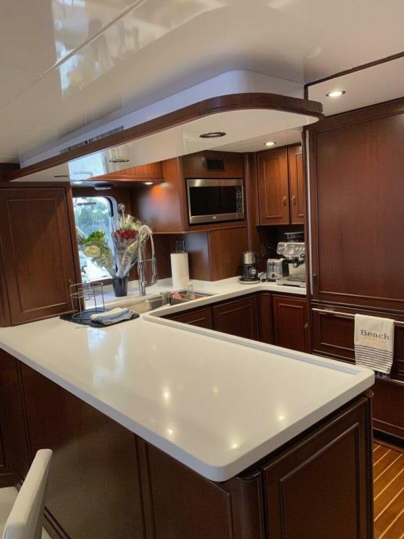 a kitchen with wooden cabinets aboard PRECIOUS CARGO Yacht for Sale
