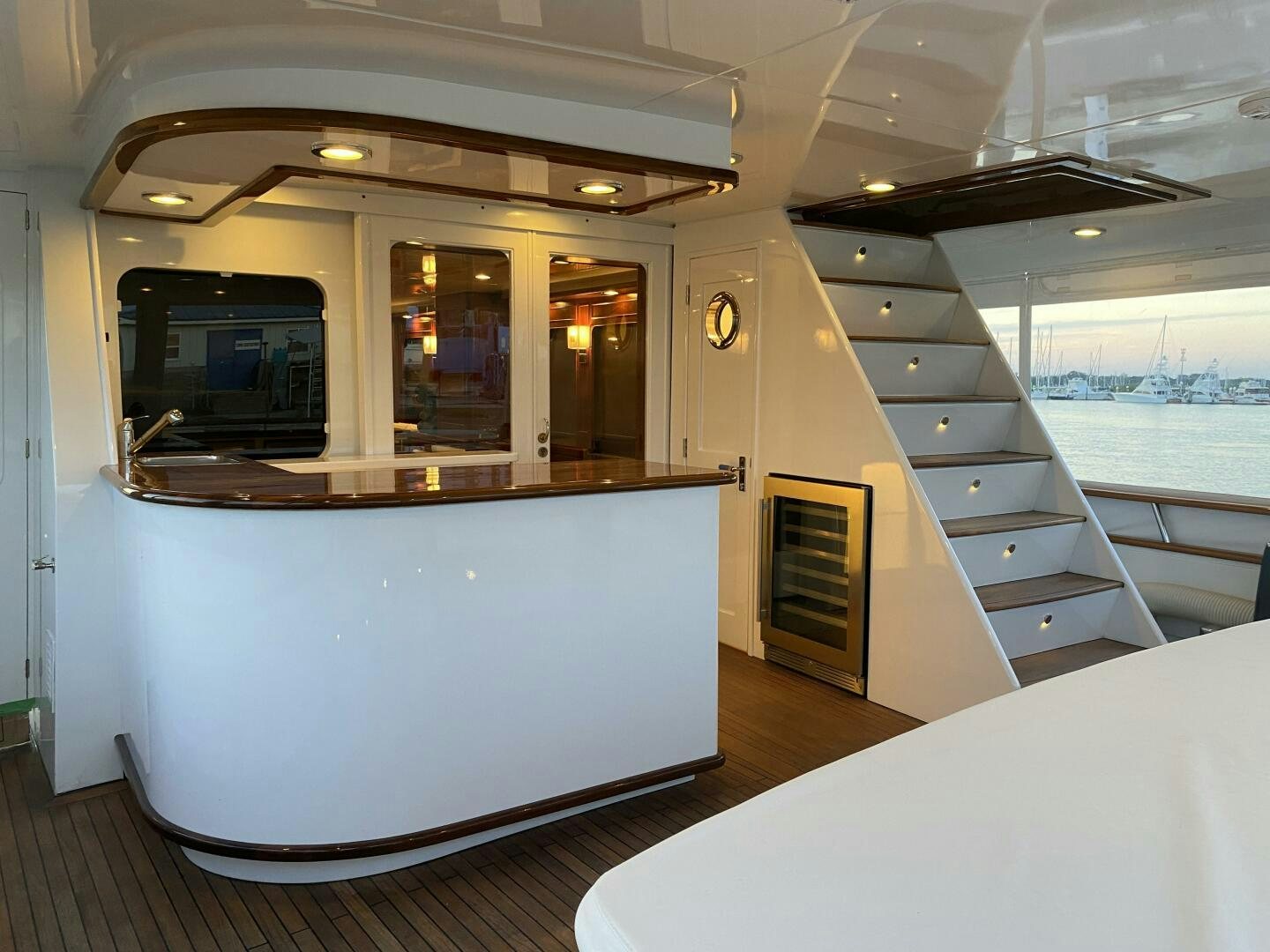 a room with a large window and a table with chairs and a view of the water aboard PRECIOUS CARGO Yacht for Sale