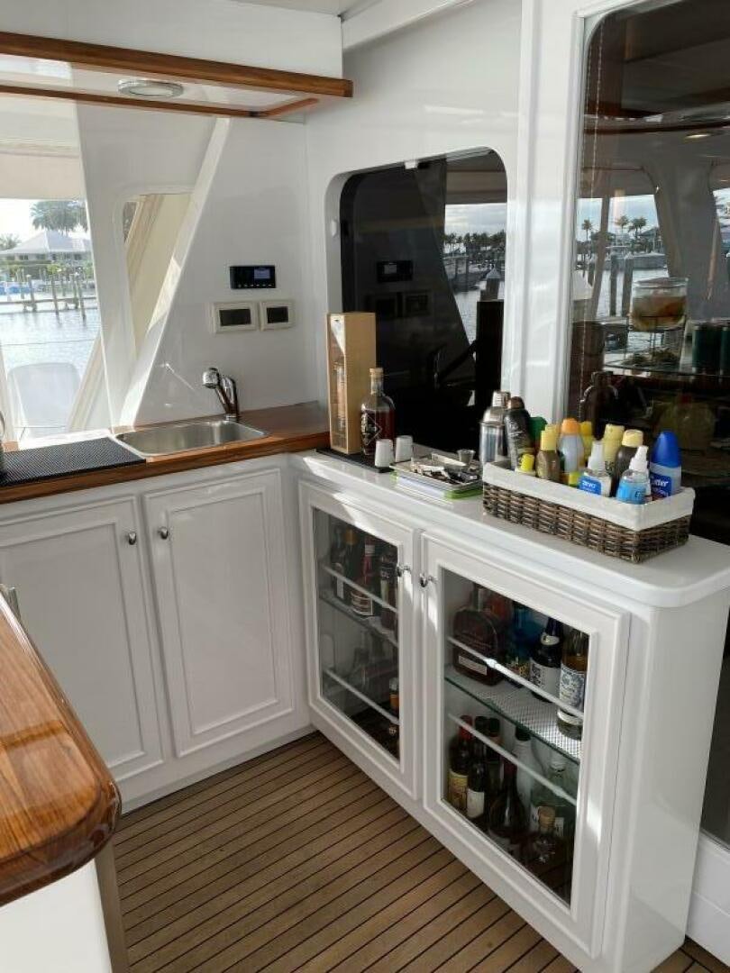 a kitchen with a fridge and sink aboard PRECIOUS CARGO Yacht for Sale