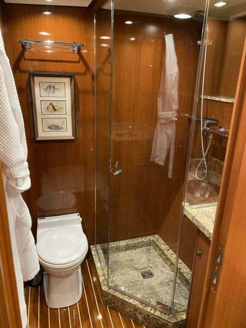 a bathroom with a toilet and a shower aboard PRECIOUS CARGO Yacht for Sale