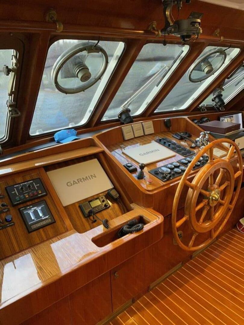 a wooden table with a large round wooden object aboard PRECIOUS CARGO Yacht for Sale