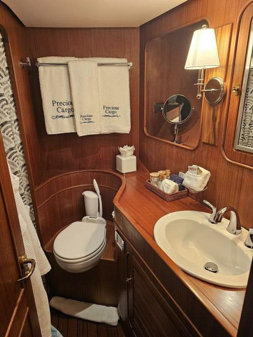 a bathroom with a toilet and a sink aboard PRECIOUS CARGO Yacht for Sale