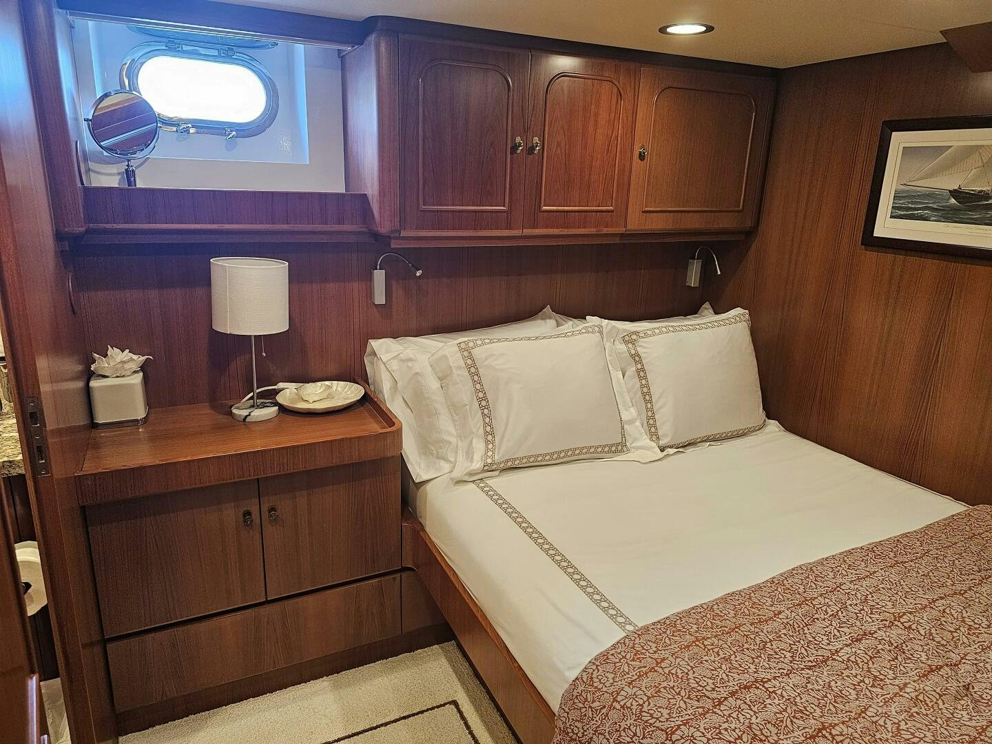 a bedroom with a bed and a dresser aboard PRECIOUS CARGO Yacht for Sale