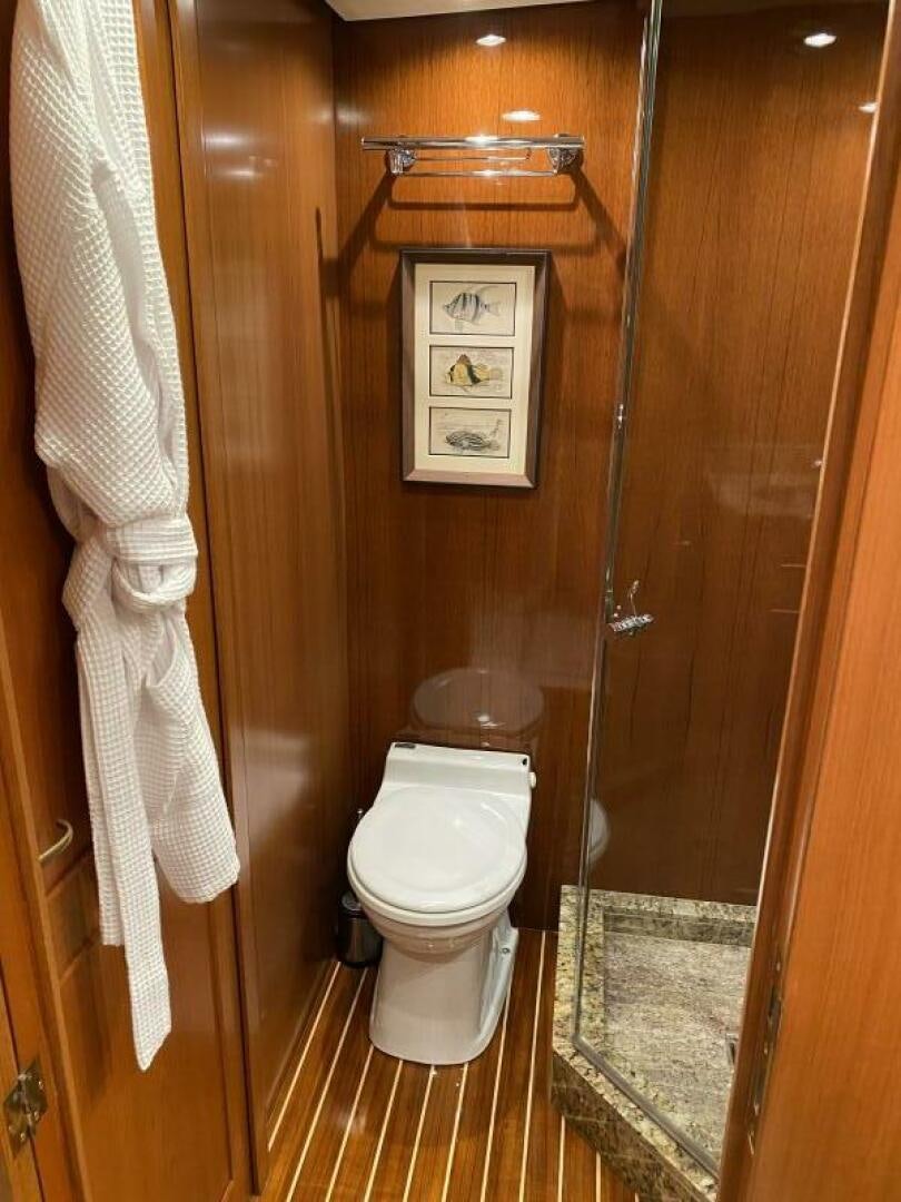 a bathroom with a toilet and a sink aboard PRECIOUS CARGO Yacht for Sale