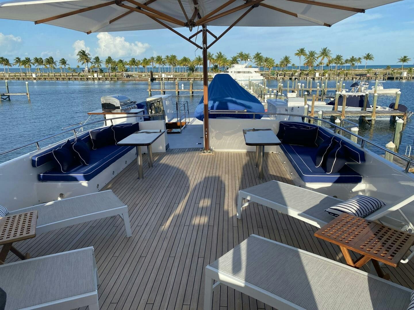 a deck with a boat and a dock with a blue sky aboard PRECIOUS CARGO Yacht for Sale
