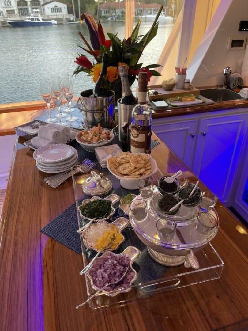 a table with food and glasses on it aboard PRECIOUS CARGO Yacht for Sale