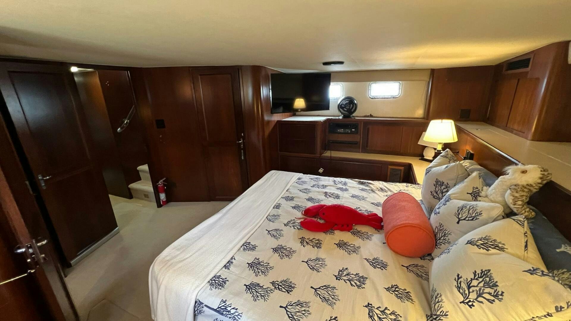 a bedroom with a bed and a desk aboard SEA OWL Yacht for Sale