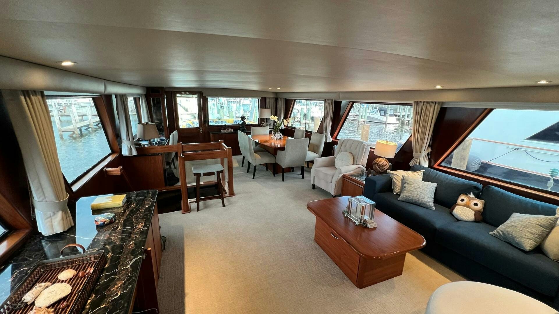 a living room with a blue couch and a table aboard SEA OWL Yacht for Sale
