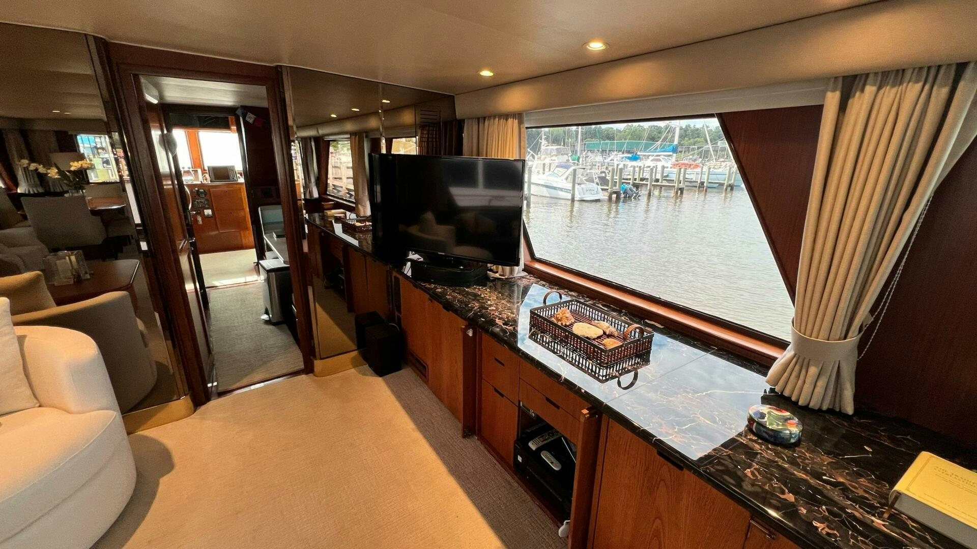 a room with a tv and a table aboard SEA OWL Yacht for Sale