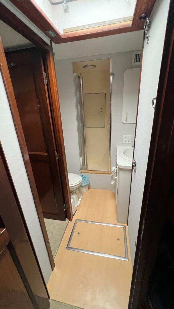 a bathroom with a toilet and a sink aboard SEA OWL Yacht for Sale