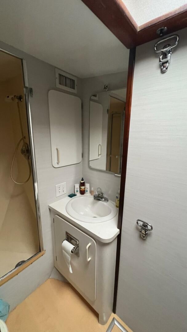 a bathroom with a sink and a mirror aboard SEA OWL Yacht for Sale