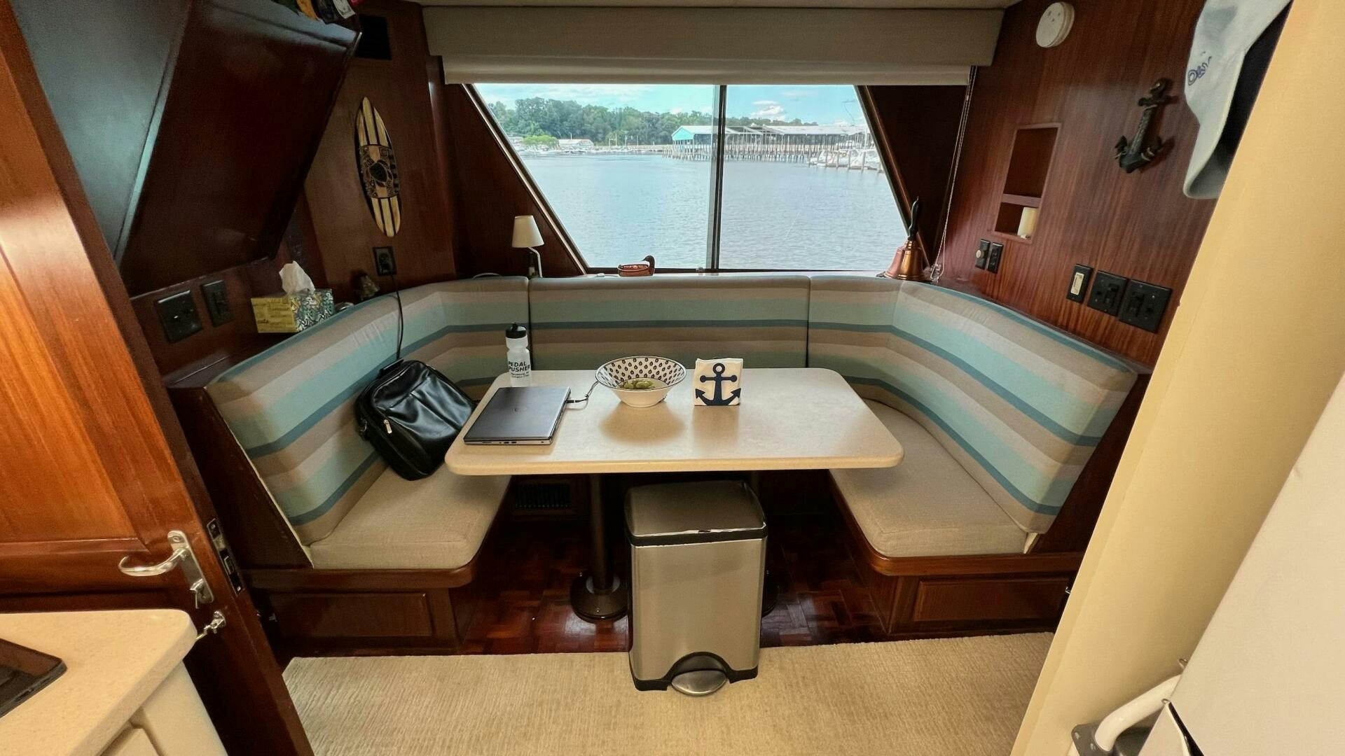 a room with a table and a laptop on a table aboard SEA OWL Yacht for Sale